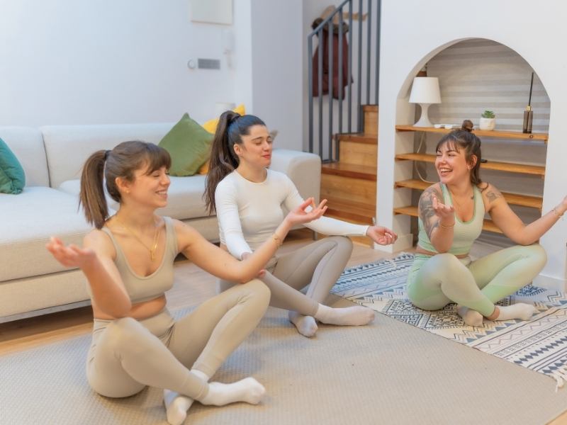 Dayrise Blog Images 1 - Dayrise Wellness Three women laughing and relaxed together at home, representing reconnection and joy as part of trauma recovery